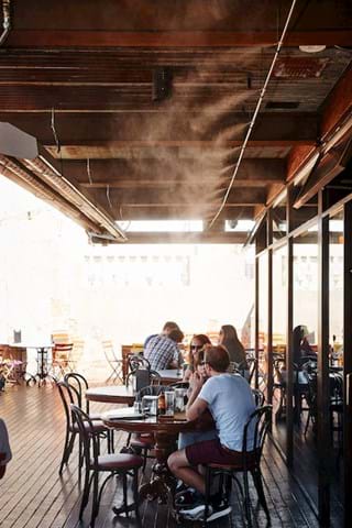 Static misting lines in an outdoor dining area
