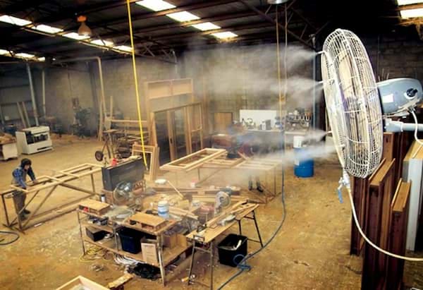 High pressure misting fans in a factory workshop.